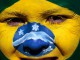 Яркие краски на лице бразильской фанатки перед началом матча между Бразилией и Голландией.