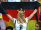 Болельщица сборной Германии празднует победу своей команды.