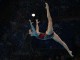 Синхронистка исполняет акробатический прыжок во время выступления сборной России на чемпионате мира в Барселоне