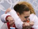Российская фигуристка Аделина Сотникова обнимает своего тренера Елену Буянову после проката произвольной программы