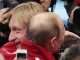 Президент России Владимир Путин обнимает фигуриста Евгения Плющенко после завоевания сборной России золота в командных соревнованиях 